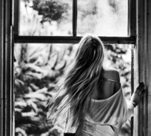 back of girl looking out window